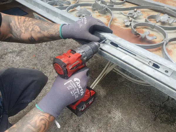 Einbau Fuhr-Türkantriegel in ein Gitter vor einer Doppeltür zur Terrasse